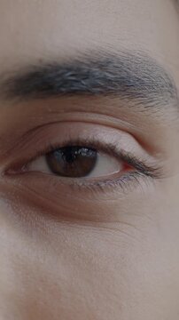 Close-up portrait of Middle Eastern man's eyes looking at camera with joy while person feeling happy and carefree. People and face expression concept.