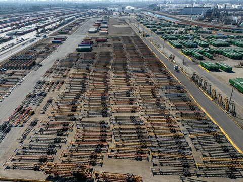 Aerial view of a vast storage yard filled with rows of container chassis and shipping containers in an industrial area in Carson, California, United States.
