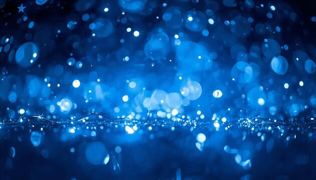 Blue bokeh lights background with festive glitter and dark copy space