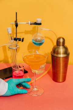 Laboratory cocktail preparation with glassware and shaker