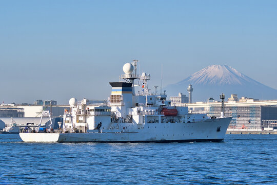 U.S. Navy Military Sealift Command USNS Mary Sears (T-AGS-65) Pathfinder-class oceanographic survey ship entering Yokohama Port with Mount Fuji and Yokohama Marine Tower in the background