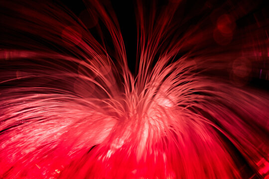 Red fiber optic light trails in abstract motion