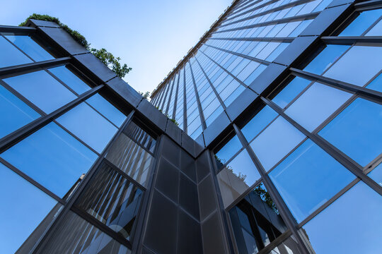 Modern glass facade in urban business district perspective