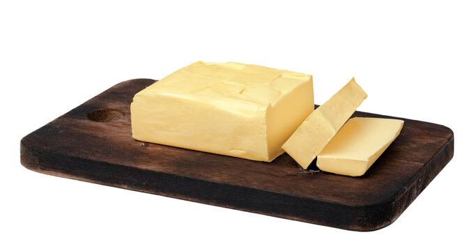 Butter block on a wooden cutting board with a slice cut off