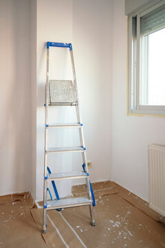 Ladder in empty room prepared for home renovation