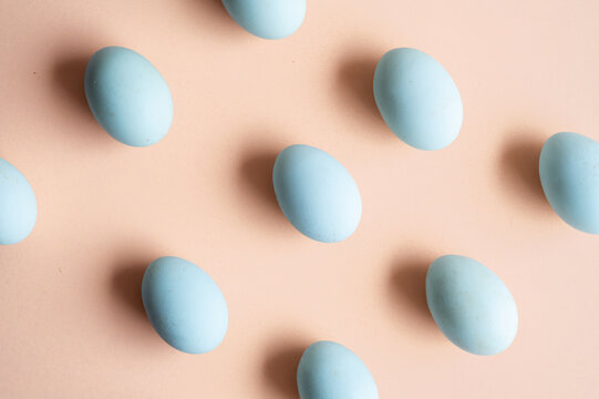 Organic natural eggs on pastel peach background