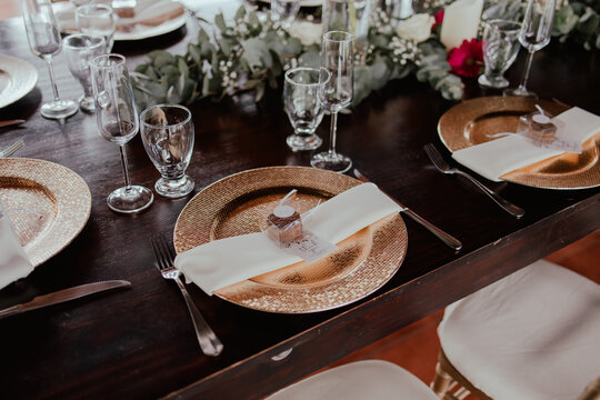 Elegant wedding reception table setting with gold charger plates