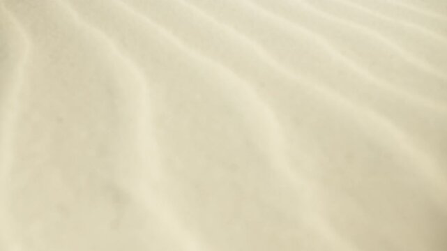 Underwater sand ripple background with sunlight creating caustic light patterns on the shallow sea floor