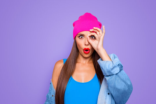 I'm spy! Follow you! Close up photo portrait of funky pretty with opened mouth lady making ok symbol with fingers near eye staring at you camera isolated bright background