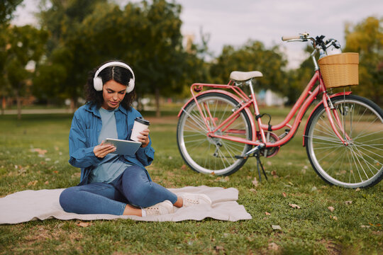 Woman enjoying leisure time in park with tablet