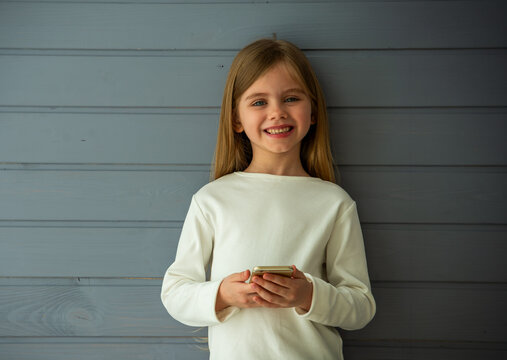 Smiling Child With Smartphone.