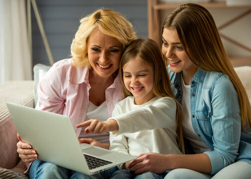 Three Generations Using Laptop.