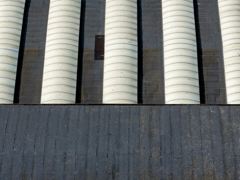 Aerial view of the repeating cylindrical roof structures of an old factory in Plock, Mazowieckie, Poland.