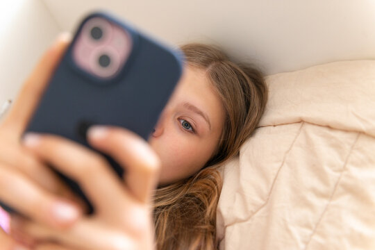 Teenager use smartphone while relax on bed at home