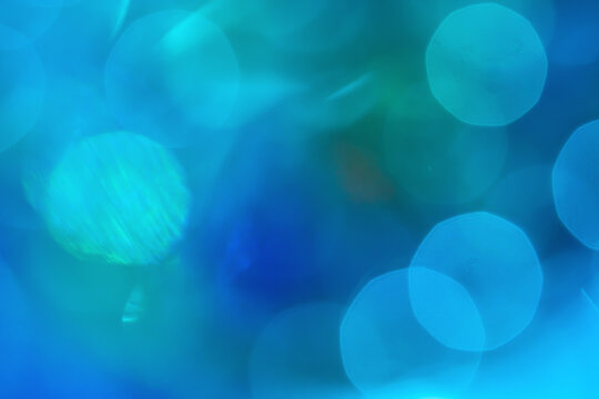Abstract blue bokeh background with luminous circular light
