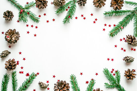 Christmas frame with fir branches, cones and red stars