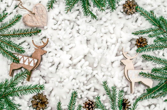 Christmas snow background with fir branches and reindeer