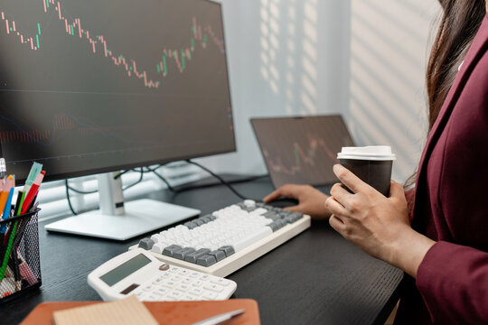Financial analyst monitoring market trends and investment performance in modern office, representing stock trading, technical analysis, portfolio management and professional financial decision making.