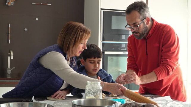 Family baking Christmas cookies together in the kitchen