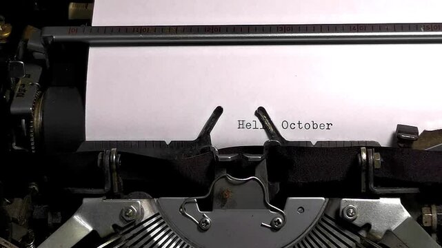 Close Up Overhead Shot of Vintage Typewriter Typing Hello October Fall Breathes New Life
