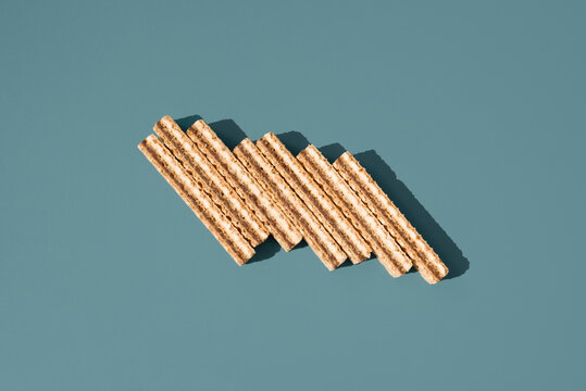 Cream and chocolate filled wafer cookies on blue background