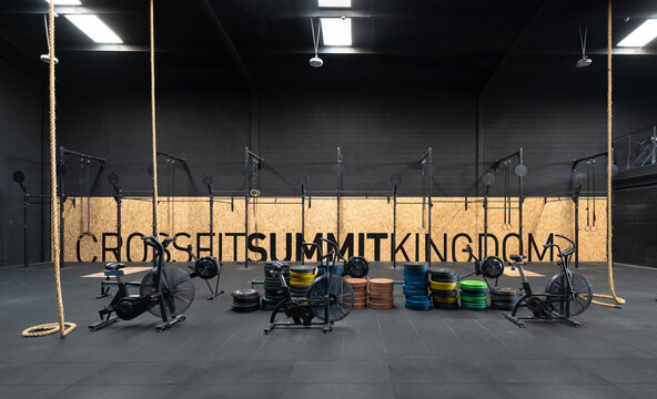 CrossFit gym interior with rowing machine and climbing rope