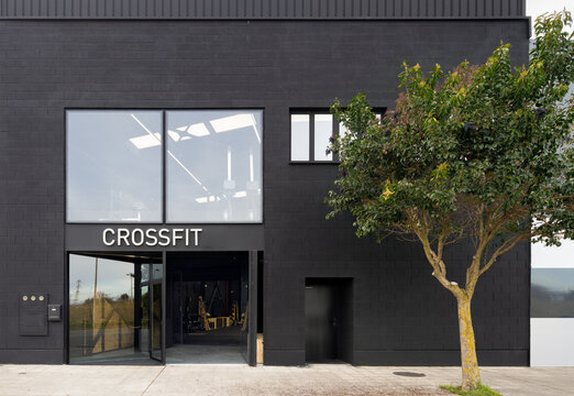 CrossFit gym entrance on modern black building exterior
