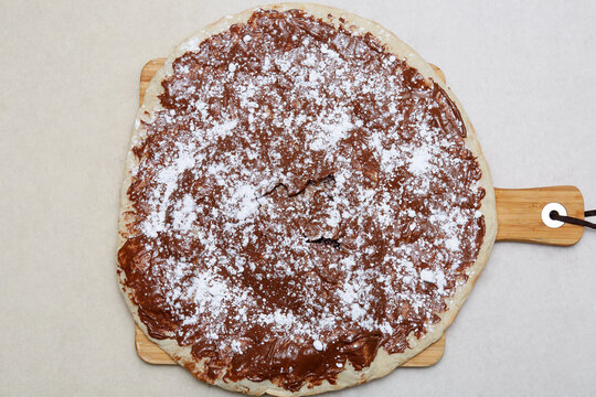 Italian chocolate pizza dessert with powdered sugar topping