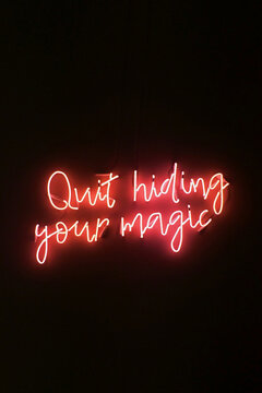 Neon sign with motivational quote Quit hiding your magic