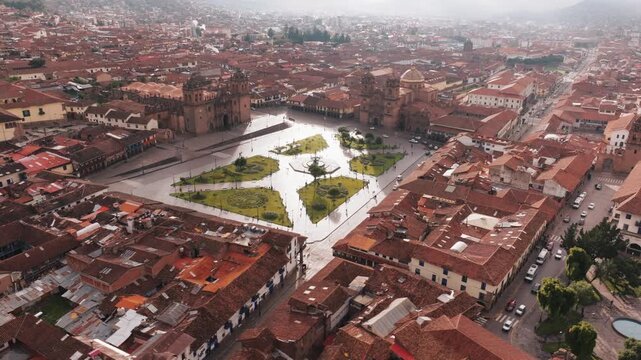 Atmospheric aerial drone view over historic Cusco city and the surrounding Andes Mountains in Peru