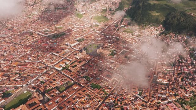Elevated aerial drone view over historic Cusco city and the surrounding Andes Mountains in Peru