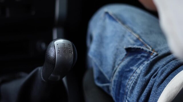 close up hand of car gear stick selector 5 speed. concept transport travel.
