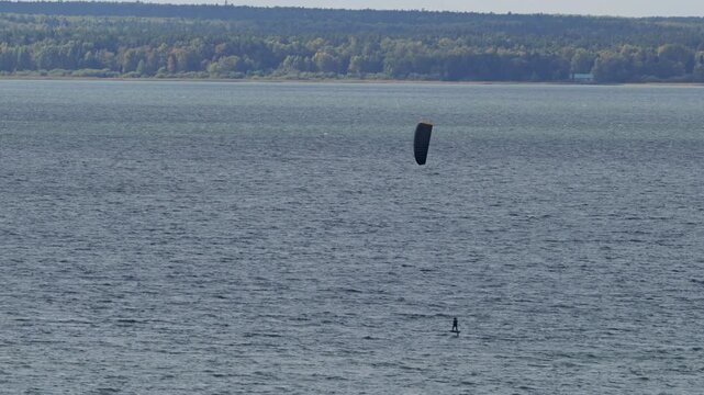Kitesurfing on the lake on a windy summer day.
