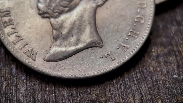Detail video of an antique gulden coin highlighting the small VDK mark on the neck area, along with engraved portrait features, aged metallic texture, rim details, and historical numismatic character.