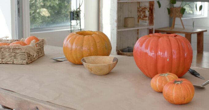 Camera is starting to pan right revealing pumpkin cluster on table to showcase halloween decor