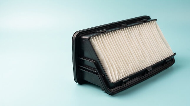 New car engine air filter with pleated paper element on clean background