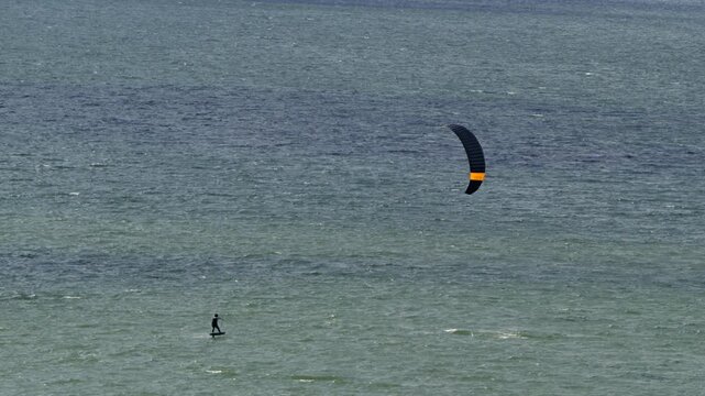 Kitesurfing on the lake on a windy summer day.