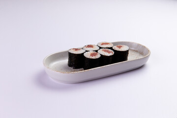 Tuna maki sushi rolls on ceramic plate food preparation © Игорь Соколов