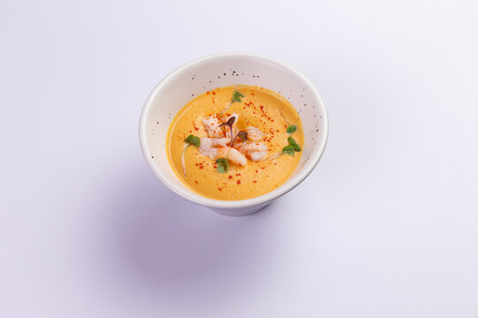 Creamy shrimp bisque in ceramic bowl fine dining food preparation