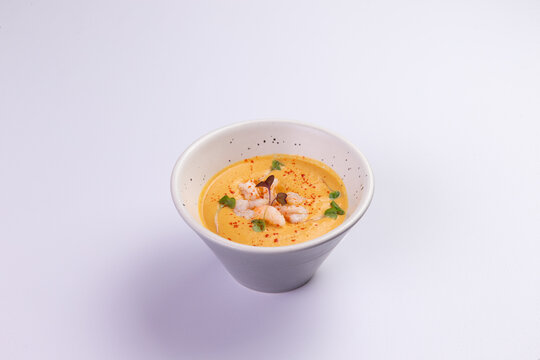 Creamy shrimp bisque in ceramic bowl fine-dining food-preparation