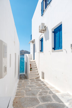 Charming alleyway in Naousa with blooming bougainvillea in Paros Greece