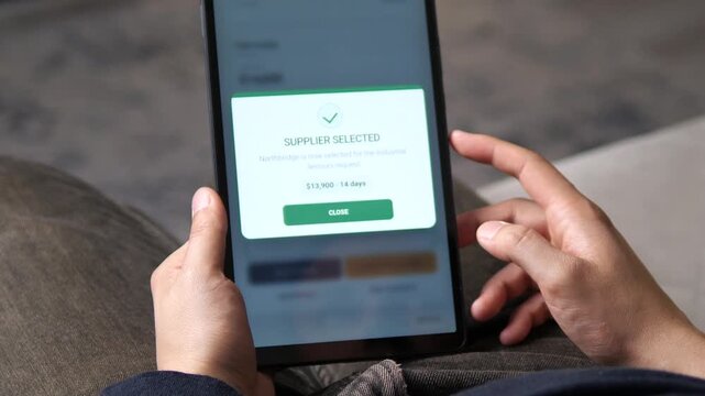 Procurement specialist confirms a supplier on a tablet, highlighting digital purchasing, competitive sourcing, cost control and modern supply chain management.