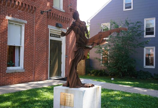 Havre de Grace, Maryland, U.S.A - Sept 2, 2026 - The Goddess Freya Sculpture, a metal artwork by Christopher Williams displayed on a pedestal outside a brick building's box office.