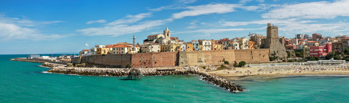 Termoli Old Town aerial panoramic drone view Castello Svevo Molise Italy colorful pastel houses on promontory over turquoise Adriatic Sea beach and medieval castle walls