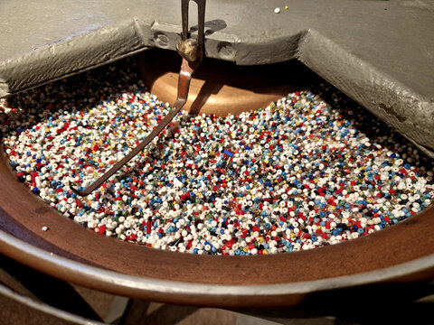 detailed view of a bead spinner, which is used for quick and efficient stringing of small glass seed beads Centrifugal force large amount of seed beads is poured into bowl.  spun either mechanically b