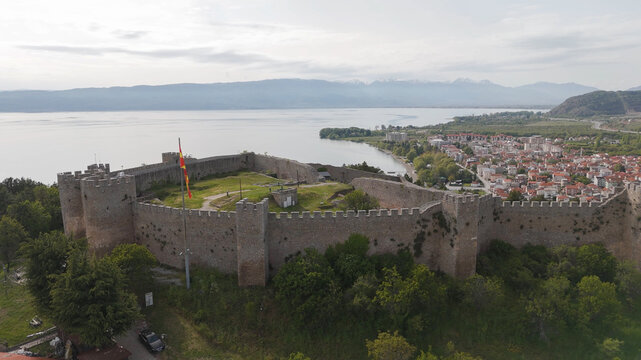Aerial view of Samuel's Fortress overlooking Lake Ohrid with the town of Ohrid in the background, surrounded by lush trees and mountains in Ohrid, Municipality of Ohrid, North Macedonia.