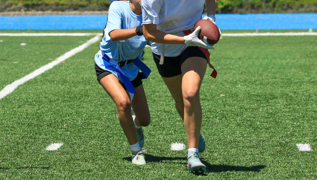 Defender Pulling the Flag of Opponent During a Girls Flag Football Game