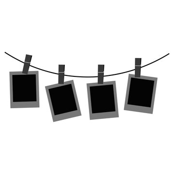 Four vintage film cameras hanging on a clothesline with clothespins