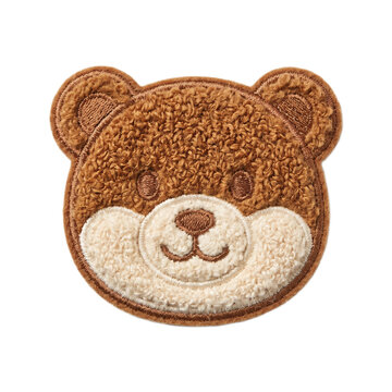 Fluffy brown teddy bear face patch with embroidered features, isolated on a white background, perfect for crafts and apparel.