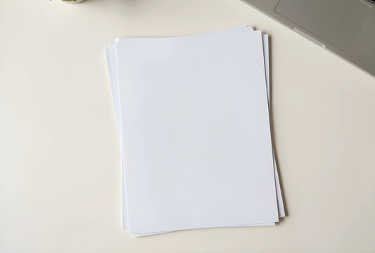 Productivity and business planning, stack of blank white paper sheets on office desk with laptop for creative writing or corporate document mockup